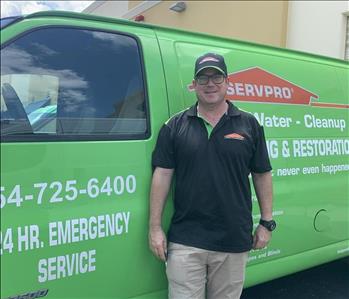 Felix in front of a SERVPRO truck
