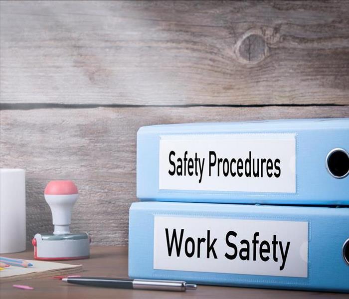 Work Safety and Safety Procedures. Two binders on desk in the office. Business background.